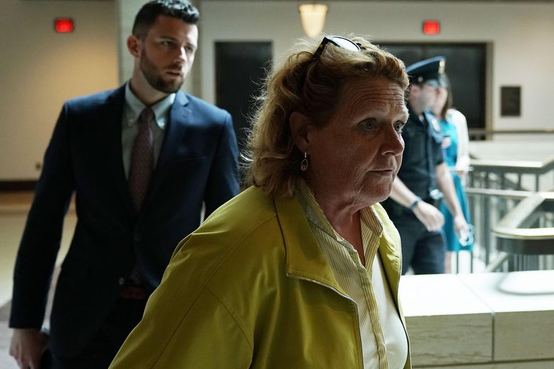 Heidi Heitkamp walking with a staffer.